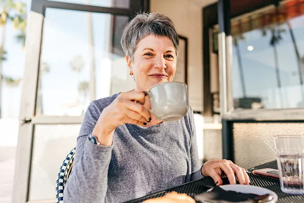 woman sitting outside having coffee